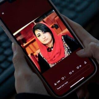 A portrait of Mursal Nabizada, a former member of the Afghan Parliament, appears on a mobile phone.