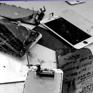 A black and white image of various broken phones and cracked screens.