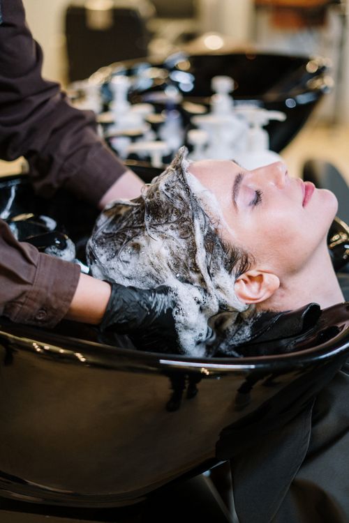 Hair being washed gently at a salon sink