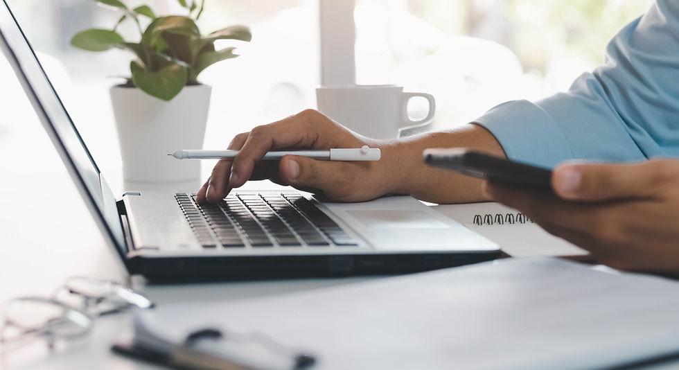 Closeup of laptop and pen