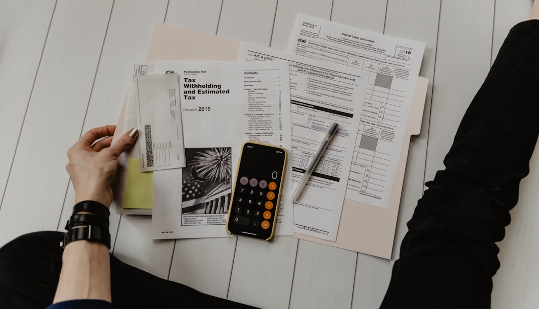 Contractor and homeowner reviewing a cost estimate and floor plan