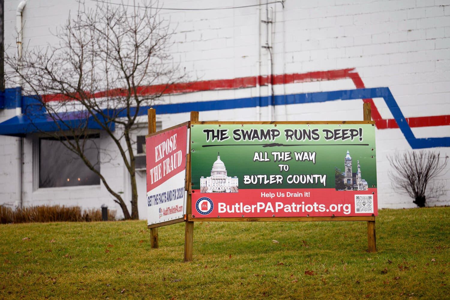 A sign says “The swamp runs deep! All the way to Butler County.”