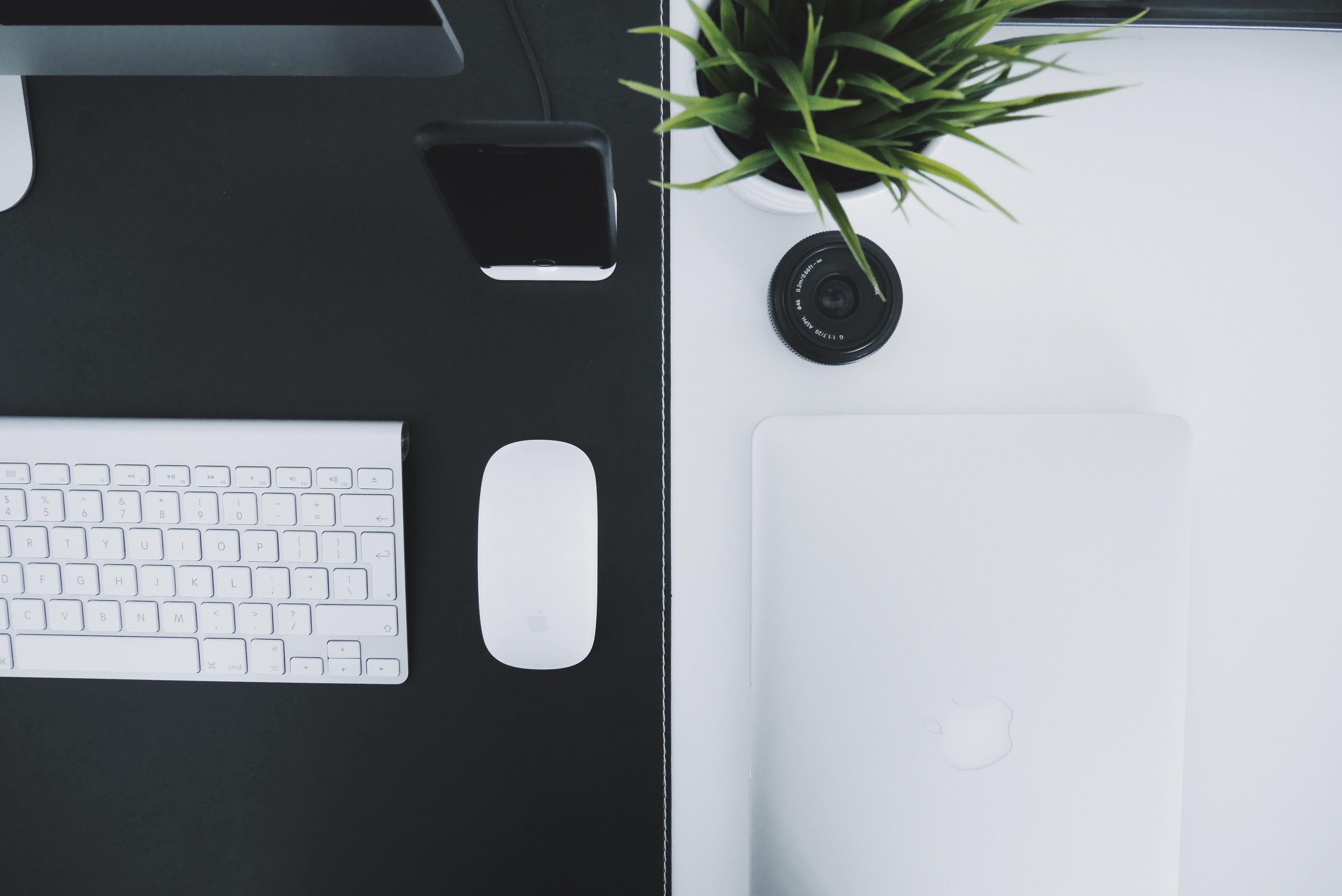 White Macbook Beside Apple Magic Mouse and Apple Magic Keyboard