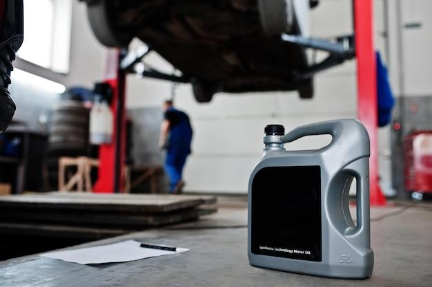 Car repair and maintenance theme Gray plastic canister of motor oill in auto service