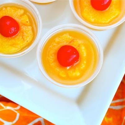 Photo: Pineapple Upside down Jello Shots :D ~Frisky  Ingredients (8-10 large jello shots) 1 cup canned pineapple juice 1.5 packets Knox unflavored gelatin 1 tablespoon sugar (optional) 1 cup cake flavored vodka (or whipped vodka or vanilla) pineapple maraschino cherries plastic shot cups  Instructions Pour pineapple juice and sugar (if using) in small sauce pan and sprinkle with gelatin. Allow to soak in for a minute or two. Heat over medium heat until gelatin dissolves, stirring constantly. Remove from heat. Stir in vodka. Pour into plastic shot glasses, filling 3/4 of the way full, reserving some of the jello mixture at room temperature. Allow to set in refrigerator for about 45 minutes, or until just firm to the touch. While jello is setting, prepare pineapple garnish. Cut small rings from pineapple and place in a microwave safe bowl with a tablespoon of water. Cover and microwave on high for 3-4 minutes or until pineapple is hot and steaming. Once jello has start to set, place cooled pineapple ring and a maraschino cherry on top, and top off with a little more of the jello mixture so that everything can properly bind together. Refrigerate for at least four hours or overnight.