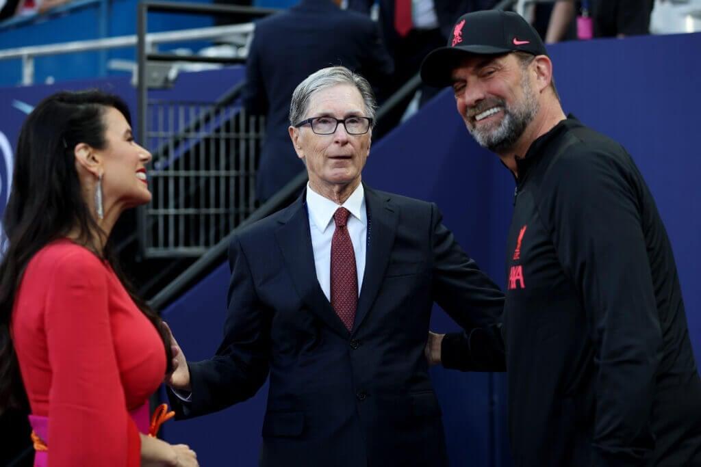 PARIS, FRANCE - MAY 28: John Henry, Owner of Liverpool with their wife Linda Pizzuti Henry embrace Juergen Klopp, Manager of Liverpool prior to the UEFA Champions League final match between Liverpool FC and Real Madrid at Stade de France on May 28, 2022 in Paris, France. (Photo by Alexander Hassenstein - UEFA/UEFA via Getty Images)