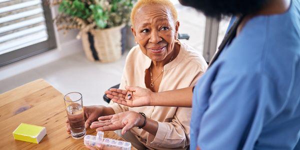 caregiver managing clients medication pillbox home care Baltimore home care Maryland home care