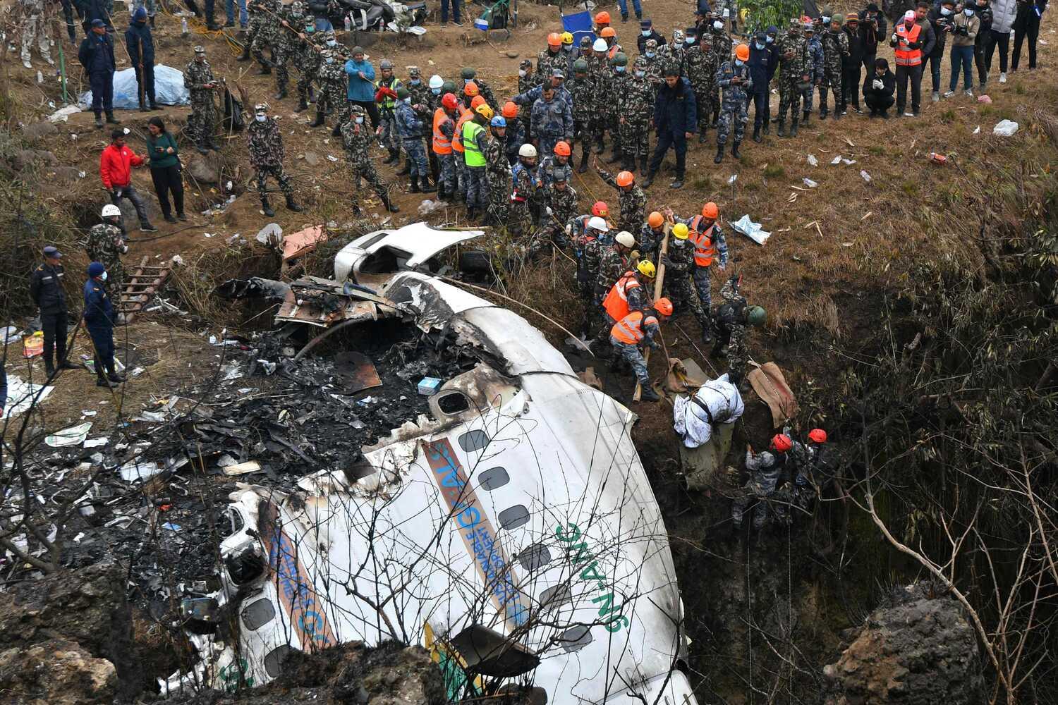 Rescuers on Monday recovering the body of a victim who died in a Yeti Airlines plane crash in Pokhara, Nepal, the day before. Seventy-two people were on the flight.