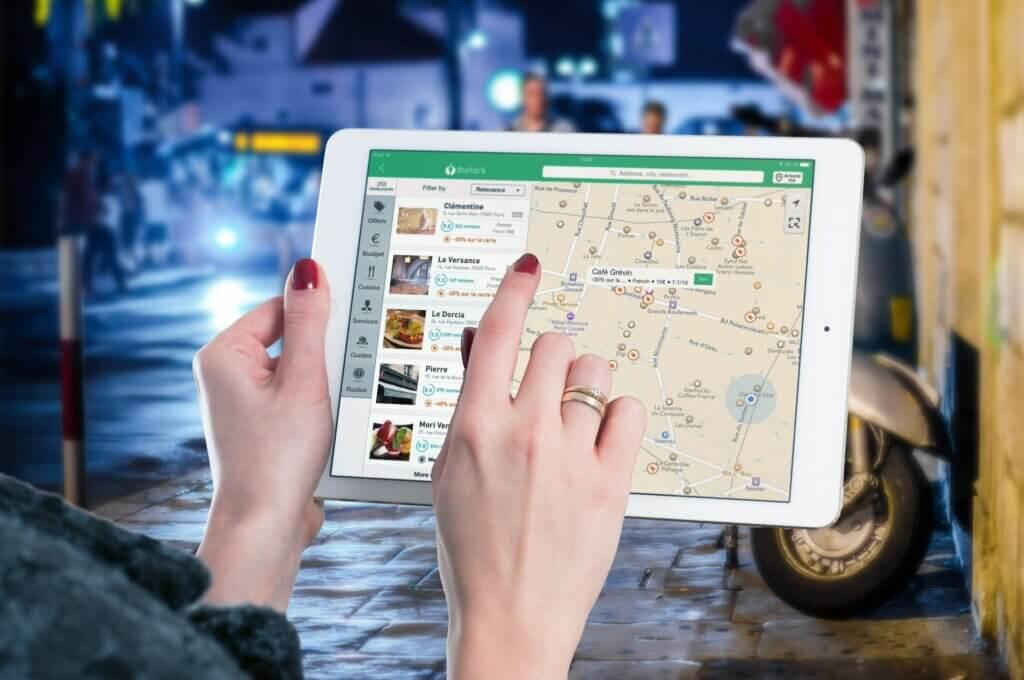 a lady choosing location in a tab device