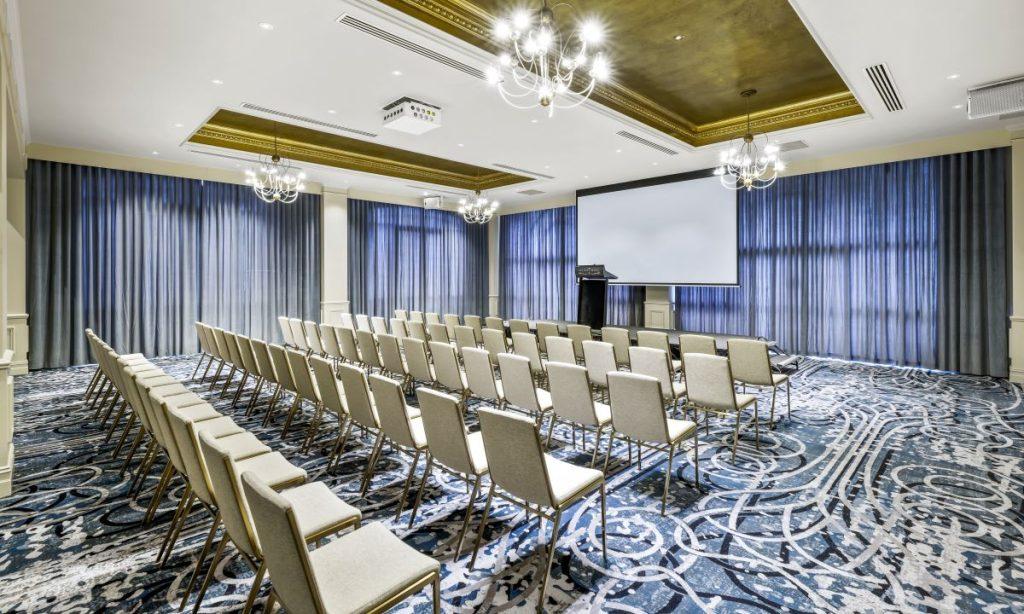 Modern ballroom theatre with tiered seating and stylish decor, an ideal function venue in Adelaide for conferences and large presentations.