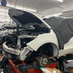 This may contain: a car that is being worked on in a garage