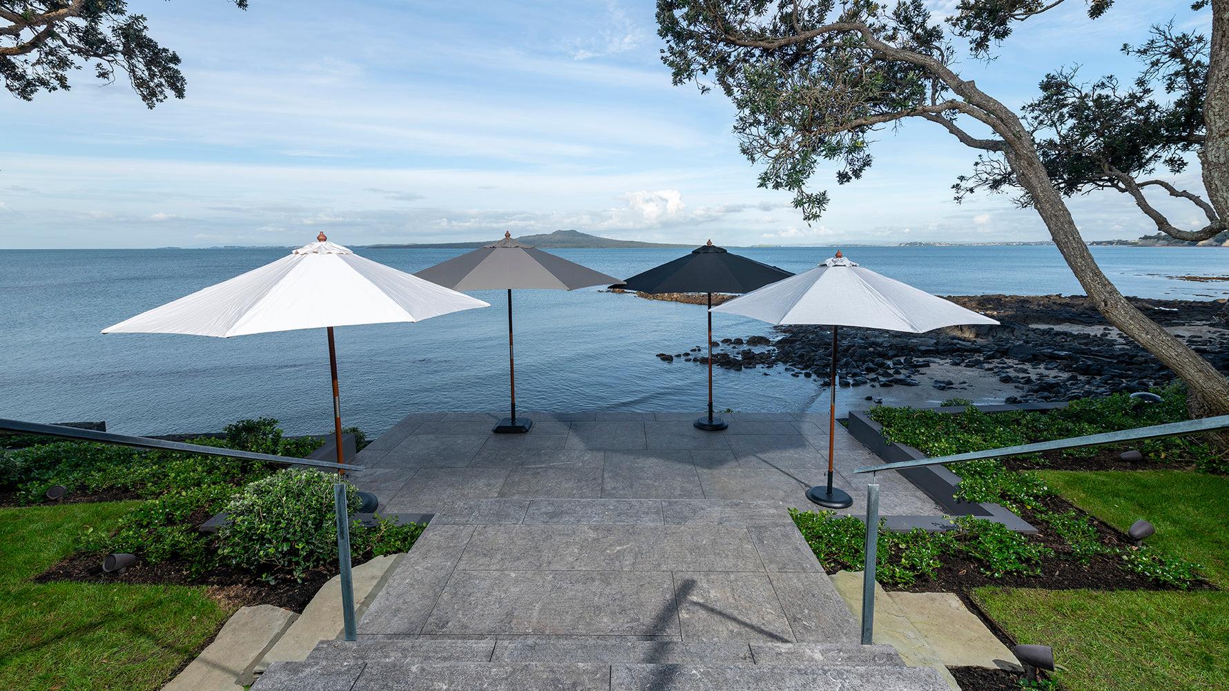 A collection of premium outdoor umbrellas from Design Warehouse, elegantly arranged to provide shade and style for patios and outdoor spaces.