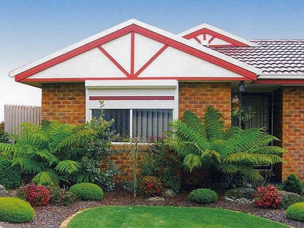 A beautiful home featuring sleek roller shutters and window shutters, enhancing security and energy efficiency while complementing the architectural design in Adelaide.