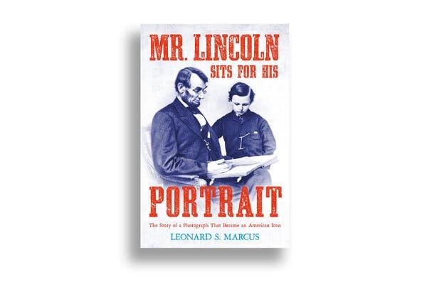 The cover of “Mr. Lincoln Sits for His Portrait,” by Leonard S. Marcus, featuring the iconic 1864 photograph of Abraham Lincoln reading to his youngest son, Tad.