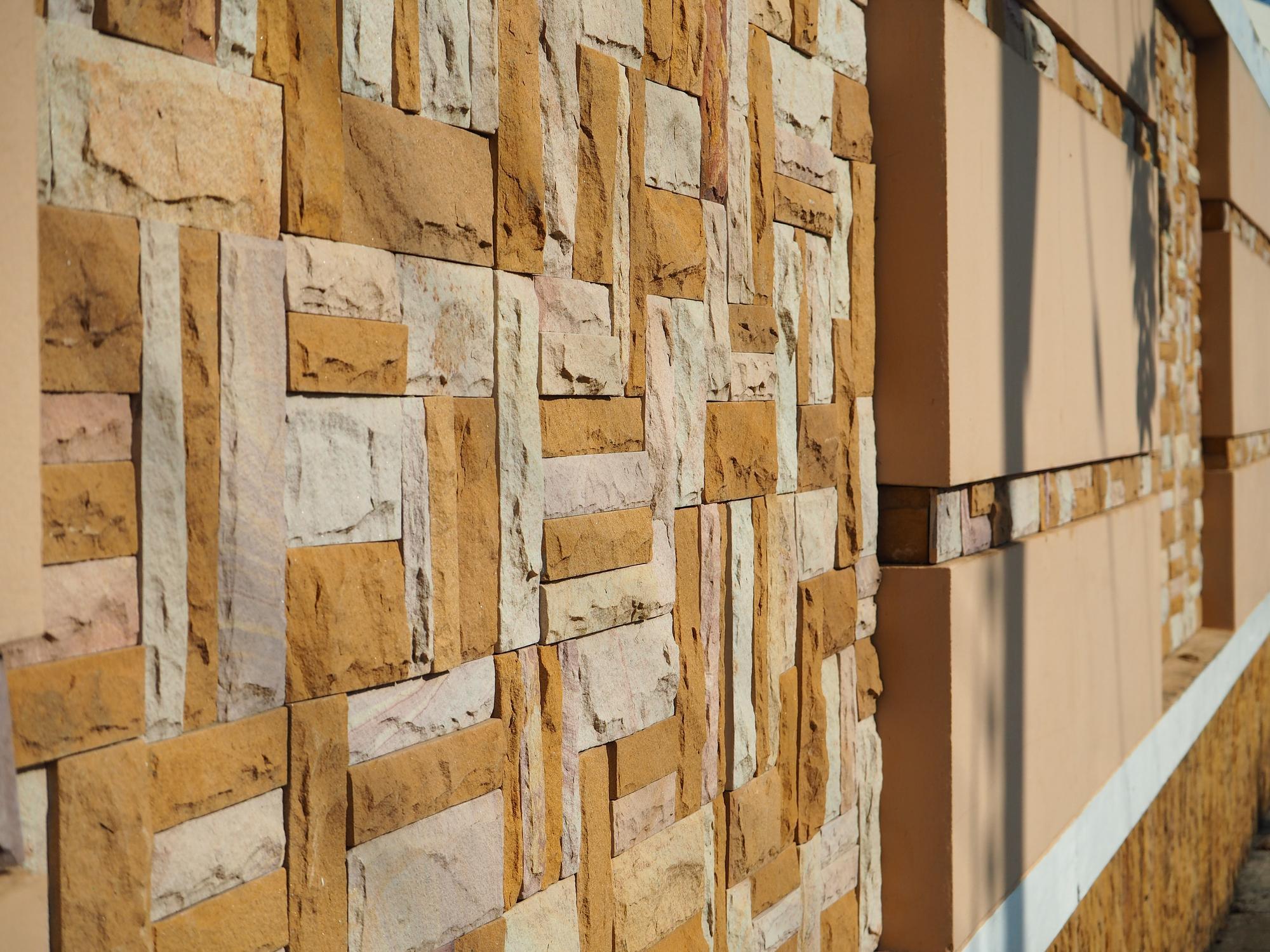 a modern stone wall cladding featuring a textured, multicolored design.