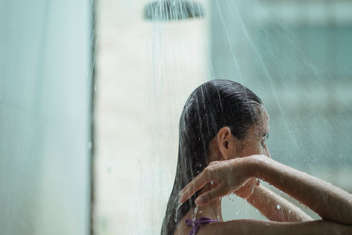 Woman rinsing her hair in the shower