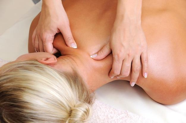 Massage of body for young woman in beauty salon