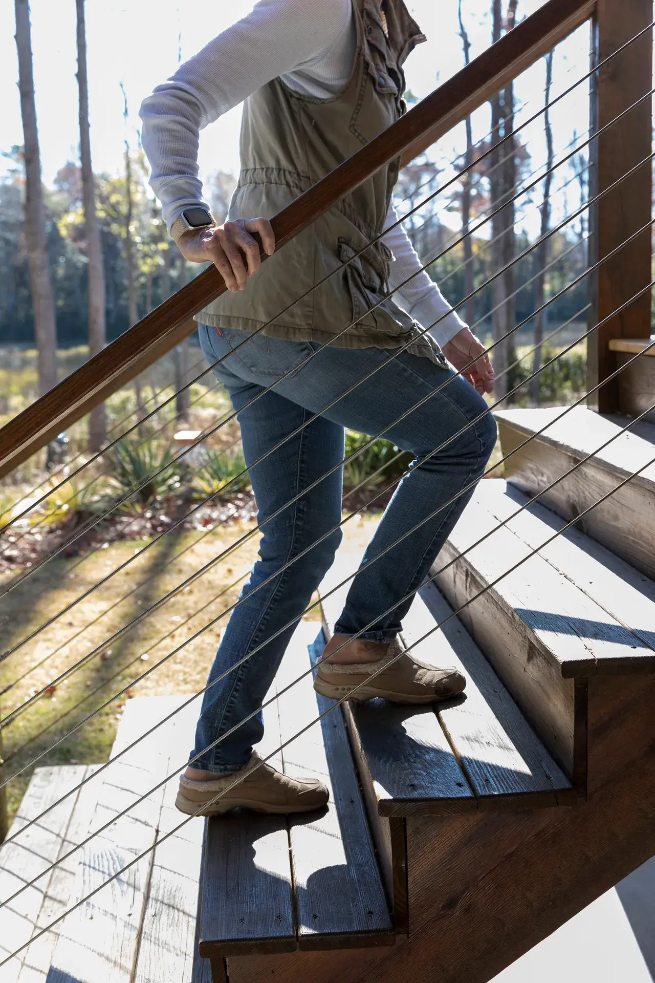 Amy Lindberg climbs the stairs up to her deck
