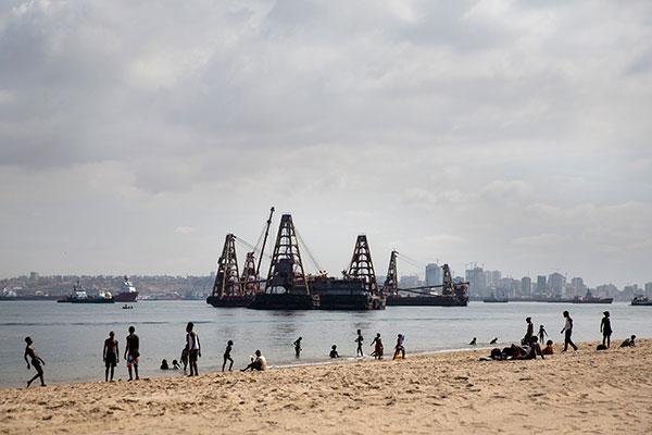The shoreline in Luanda, Angola’s capital, where heavy-lifting cranes serve as reminders of the country’s booming oil industry