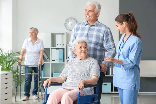 Elderly people with caregiver in nursing home - Stock Image - Everypixel