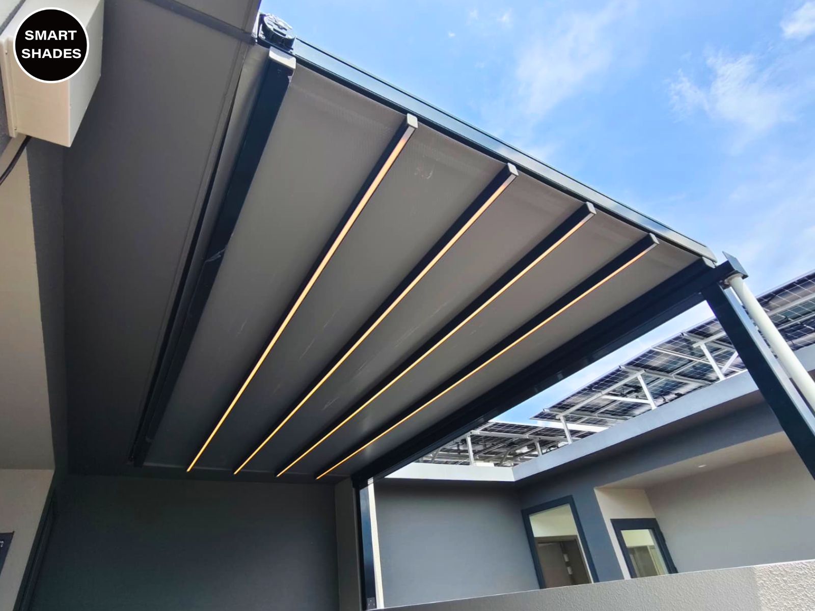 Retractable pergola covering a residential patio and seating area