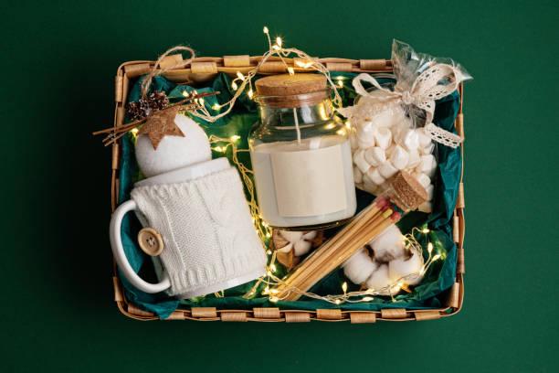 Refined Christmas gift basket for romantic holidays with aroma candle and matches. Refined Christmas gift basket for romantic holidays with aroma candle and matches. Corporate or personal present for family and friends. Corporate Gifts stock pictures, royalty-free photos & images