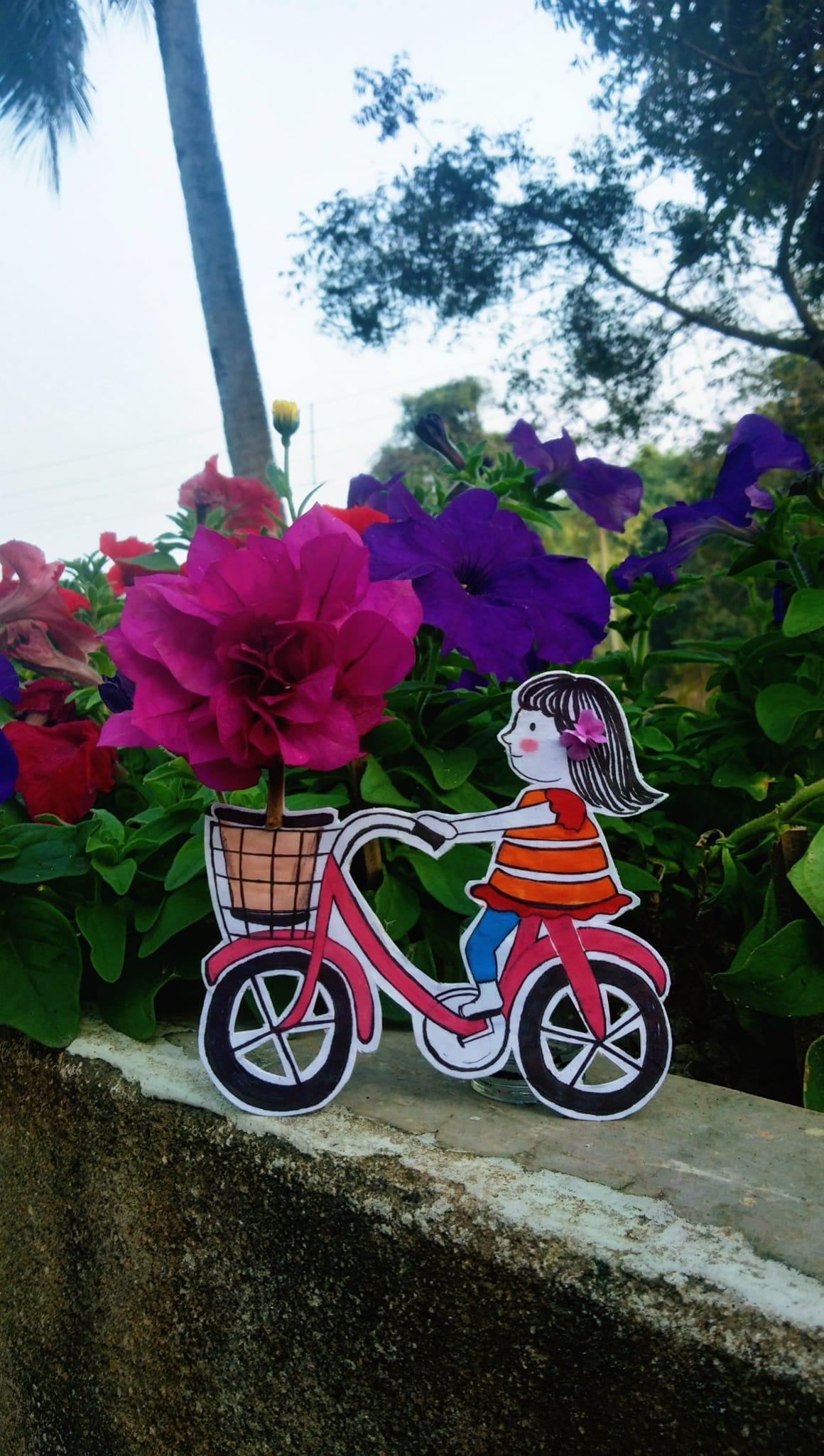May be an image of bicycle, scooter, flower and text