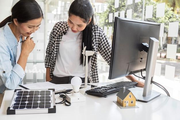 Asian women working hard together on a computer