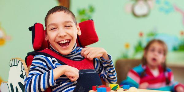 pediatric client smiling in assistive chair home care