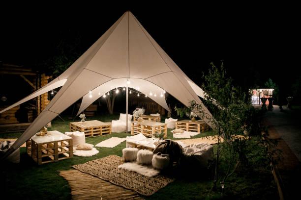 Spacious tent in the garden for a wedding party Spacious tent in the garden for a wedding party. party rentals stock pictures, royalty-free photos & images
