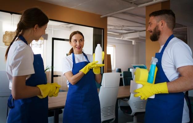 Professional cleaning service people working together in an office