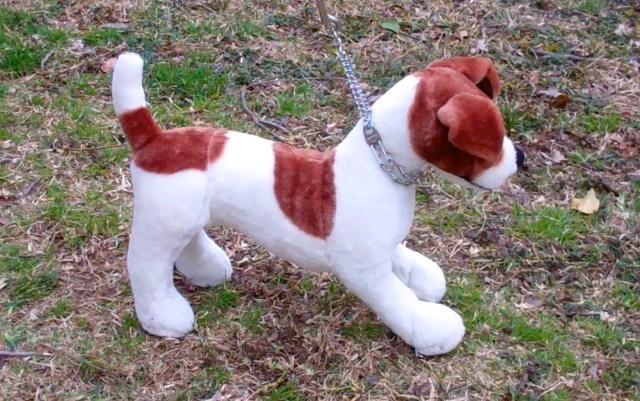 stuffed dog wearing prong collar getting leash corrections