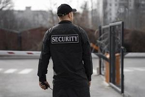 portraitmalesecurityguardwithbarbedwirefence.jpg