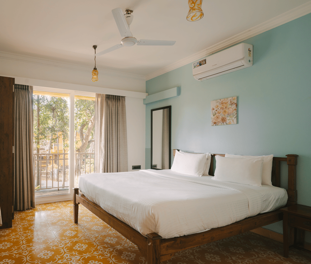 Chic bedroom with a TV and serene ambiance at One BHK Apartment, Richmonde Ananta Elite, Goa.