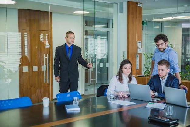 Man entering room with coworkers