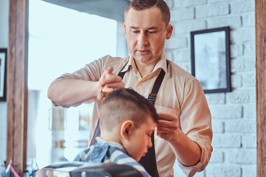 attractiveschoolboyisgettingtrendyhaircutfrommaturehairdresserfashionablehairdressingsalon1.jpg