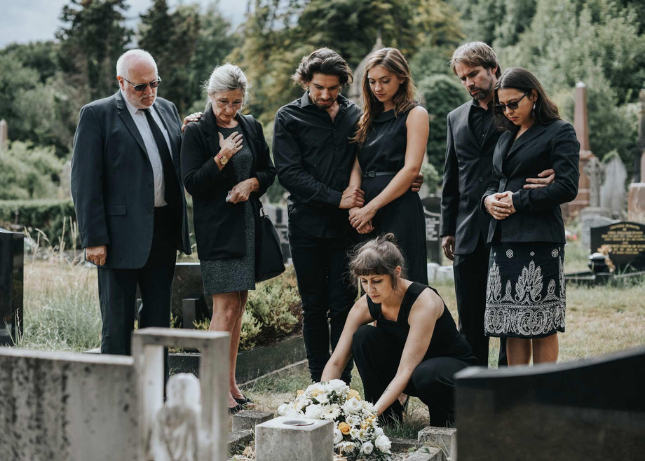 familylayingflowersonthegraveqkurhpx.jpg