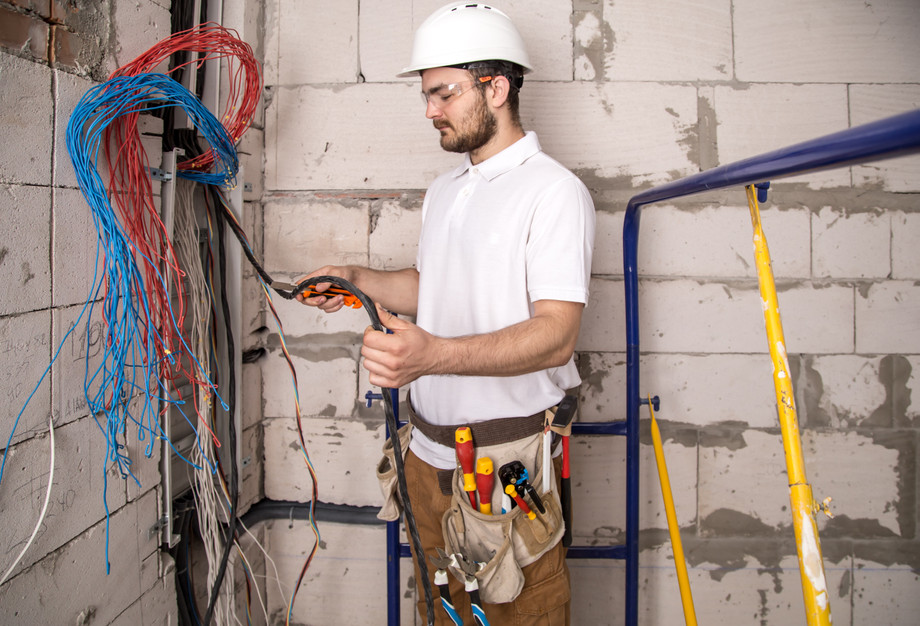 electricianworkingnearboardwithwiresinstallationconnectionelectrics.jpg