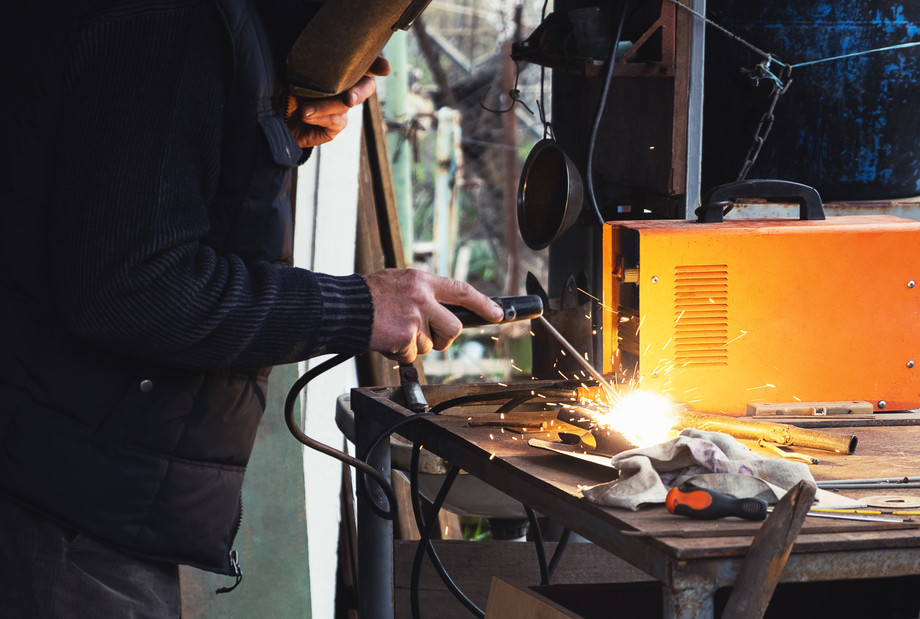 manweldingoldshovelcloseup.jpg