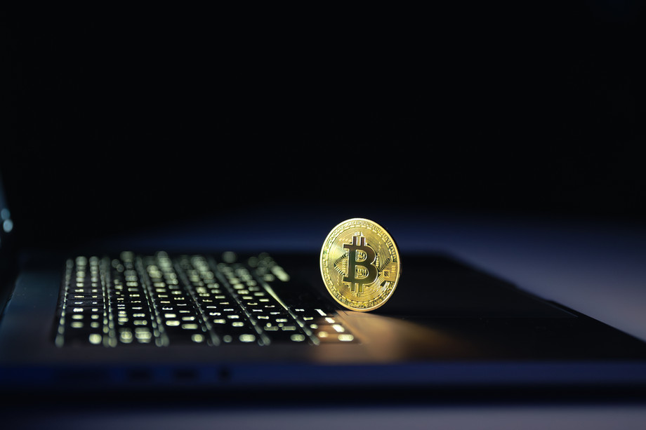 bitcoincoinnearlaptopblackbackgroundfinancecryptomoneyconcept.jpg