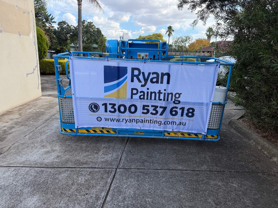 ryanpaintingboomlifthopperscrossing.jpg