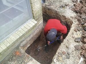 Denver Digging holes to re-level and re-support foundation.jpg