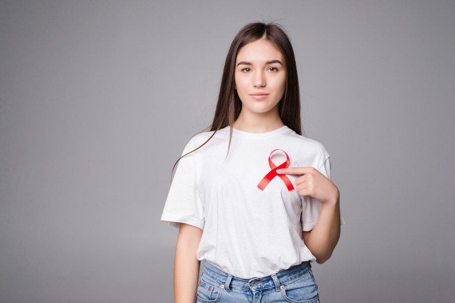 redribbonbreastcancerwomanisolatedgraywall.jpg