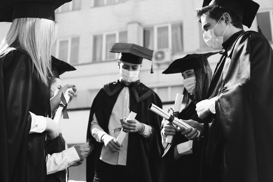 groupstudentscelebratinggraduationtogetherwearingfacemasks.jpg