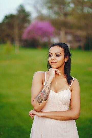 africanamericanyoungwomangrasswithlovelygreencolor_115713707.jpg