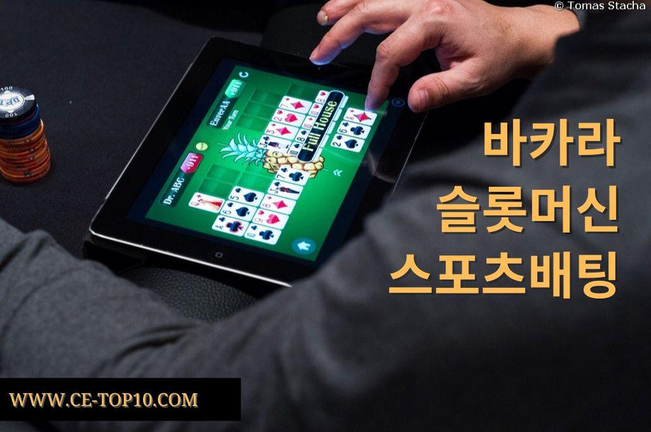 Casino player betting online poker in his tablet.