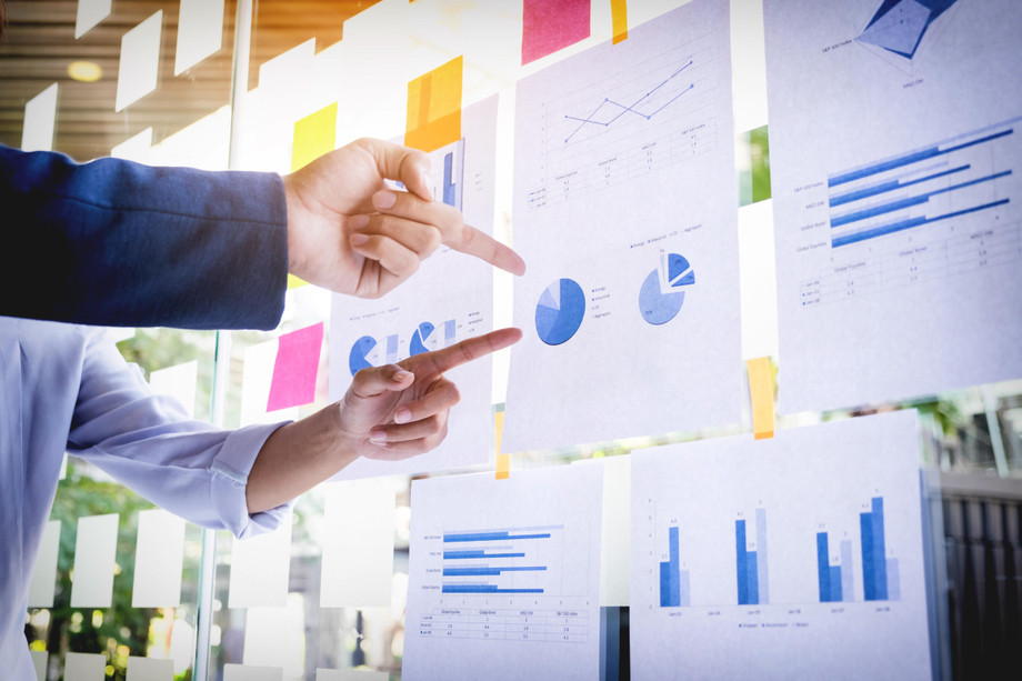 businessmanmakingpresentationwithhiscolleaguesbusinessstrategydigitallayereffectofficeasconcept.jpg