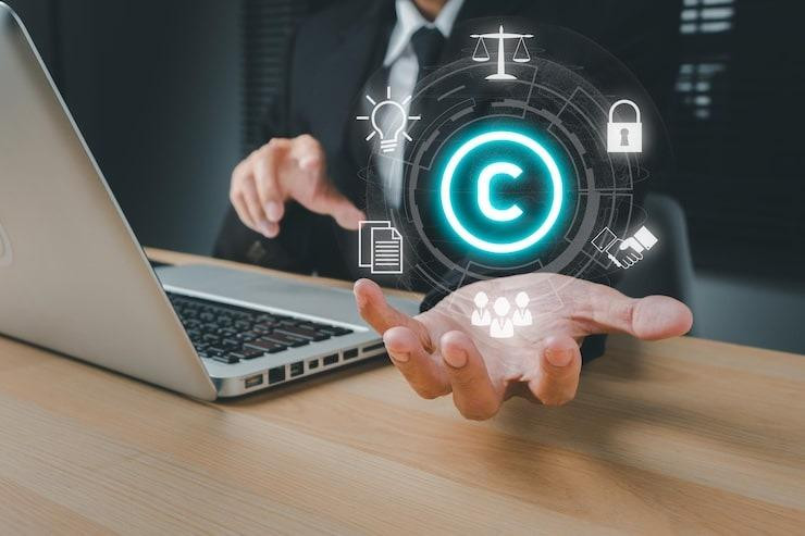 copyrightpatentconceptbusinesspersonhandholdingvrscreencopyrighticonwithbluebokehbackgroundcopylefttrademarklicensecreationownershipagainstpiracycrime_12964974179.jpg