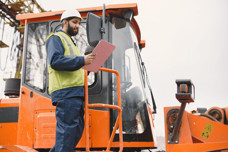 indianmanworkingmaleyellowvestmanneartractor.jpg