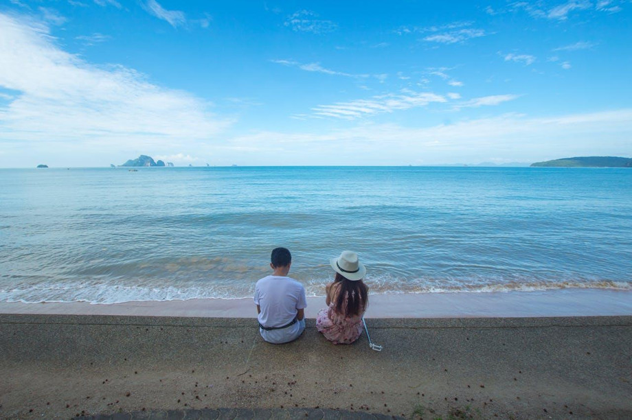 lovelycouplesittingonseashorebeautifulbeach.jpg